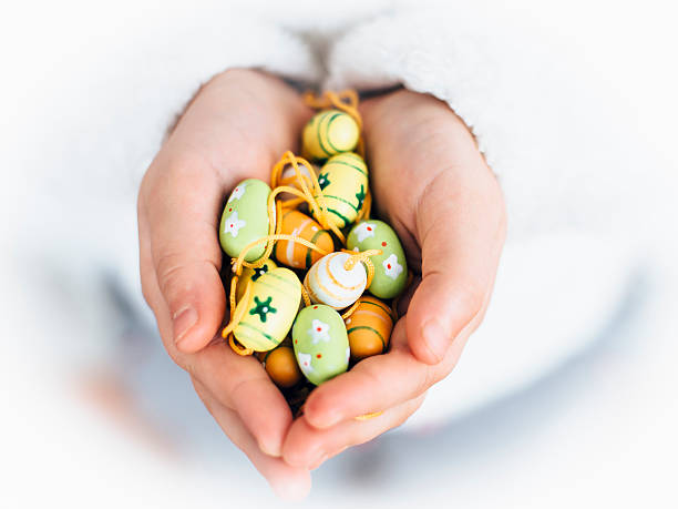istock Hands of girl holding Easter decoration eggs 505209814