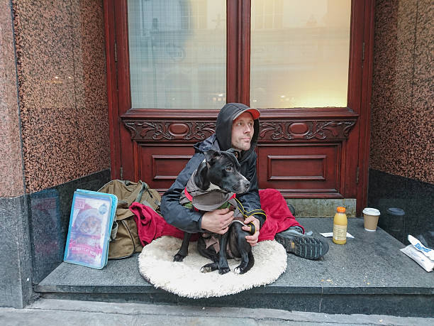 Homeless man with his dog. stock photo