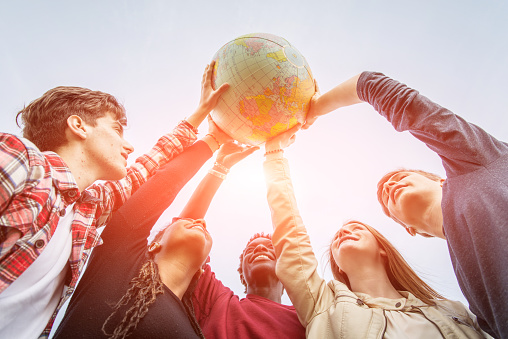 Multiracial Teen Couple Holding Globe Map - stock