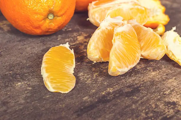 Fresh ripe sweet orange tropical fruit on wooden table. Selective focus.