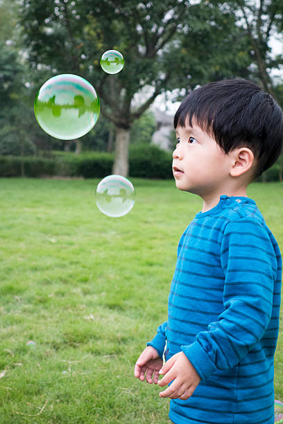 istock Cute asian boy playing with soup bubbles 505214542