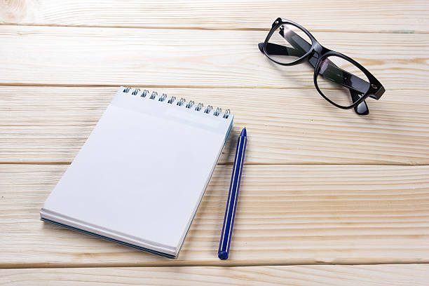 istock Back to school. Blank note pad, notebook, pen and glasses 505215454