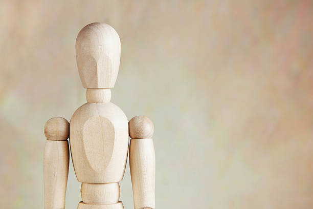 istock Wooden puppet against brown background 505217056