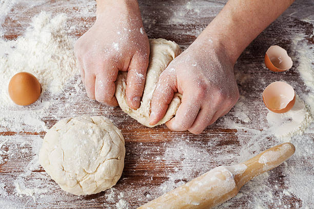 istock Dough balls with flour, eggs and rolling pin, top view 505218376