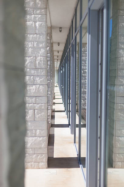 istock modern architecture corridor separating glass and stone facades 505218840