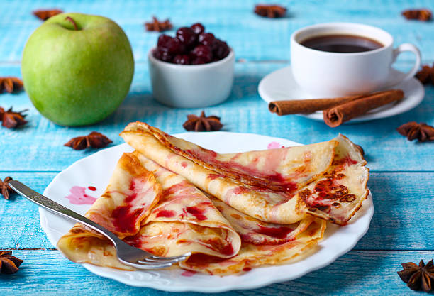 istock Breakfast pancakes with cherry jam on a blue background 505219152