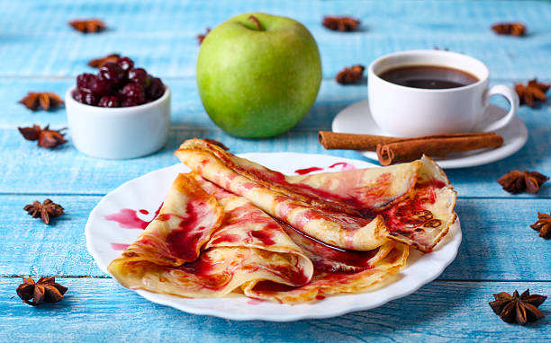 istock Breakfast pancakes with cherry jam on a blue background 505219234