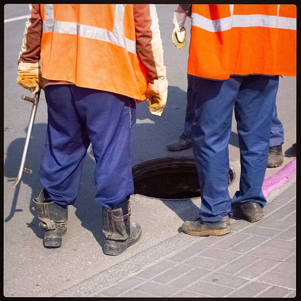 istock People near the manhole. 505219700