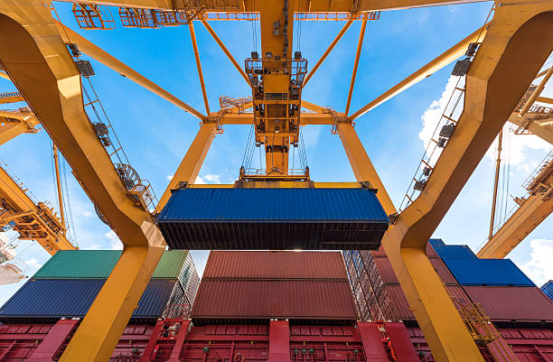 Industrial crane loading Containers in a Cargo freight ship stock photo