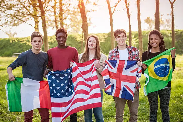 Photo of Teenage Friends Holding Flags from different Countries