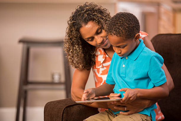 istock Learning with mom! African descent mother, child and digital tablet. 505228585