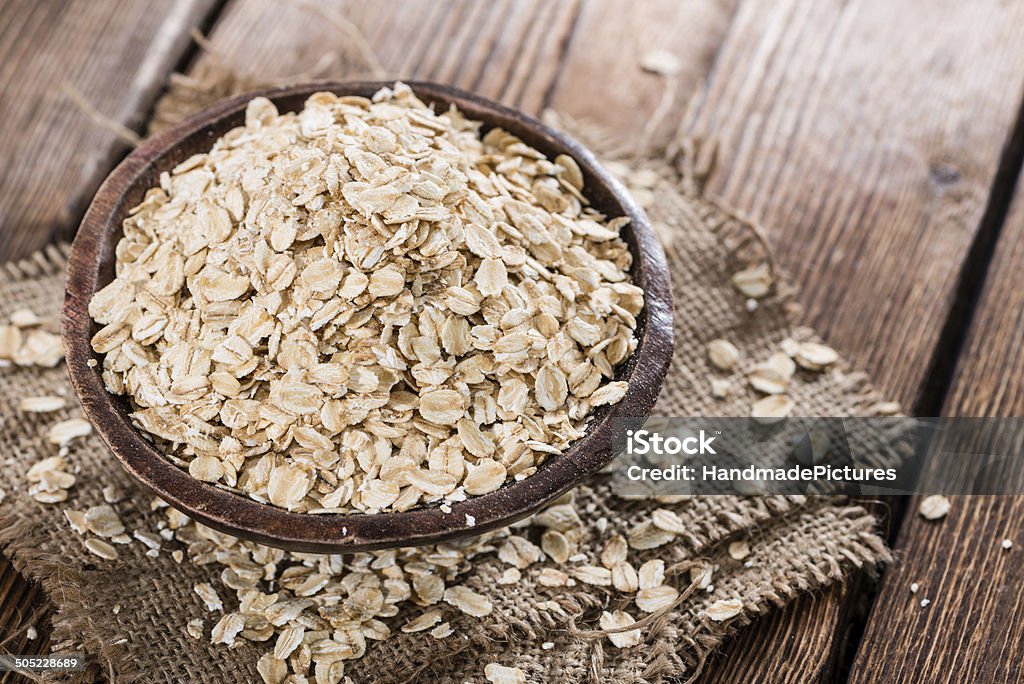 Oatmeal (close-up shot) Oatmeal (detailed close-up shot) on dark vintage wooden background Bowl Stock Photo