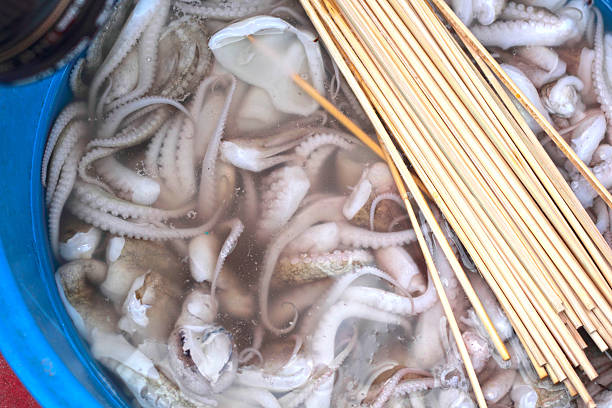 Fresh squid in market with skewers