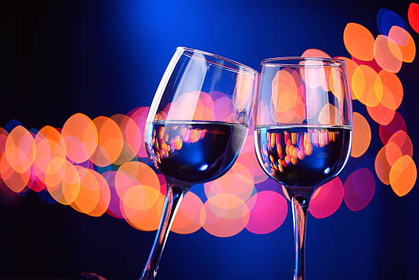istock Two wine glasses clink at the party 505229380