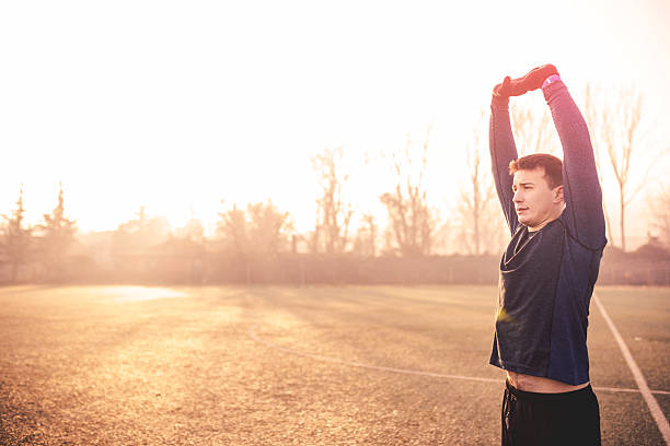 istock Male runner stretching after running in cold weather wearing run 505230292