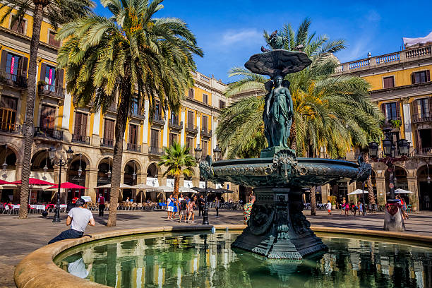 Barcelona, Spain - August 09, 2014:Historical medieval fountain and tenements in the Plaza Real in Barri Gòtic district, Barcelona, Spain