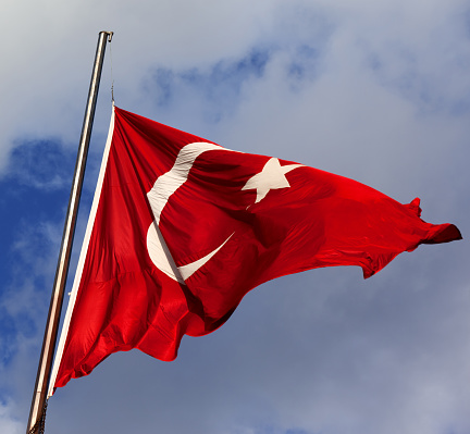 Turkish flag on flagpole at windy sun day