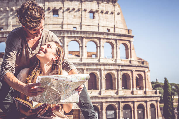 istock Tourists with guide and map in front of the Coliseum 505231699