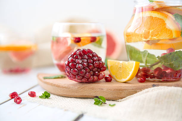 Orange Grapefruit Pomegranate and Mint Detox Water on wooden table