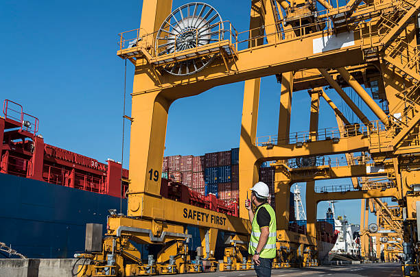 istock engineer with working crane bridge in shipyard at port 505232134