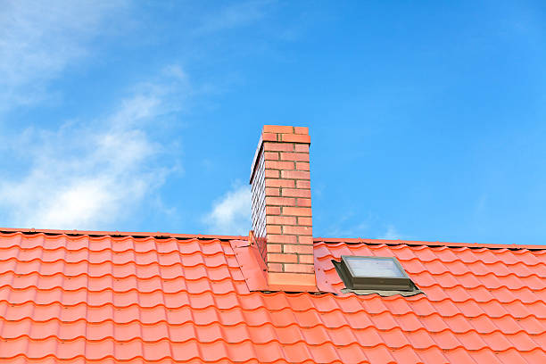 istock Roof with ceramic tile chimney against blue sky. 505232978