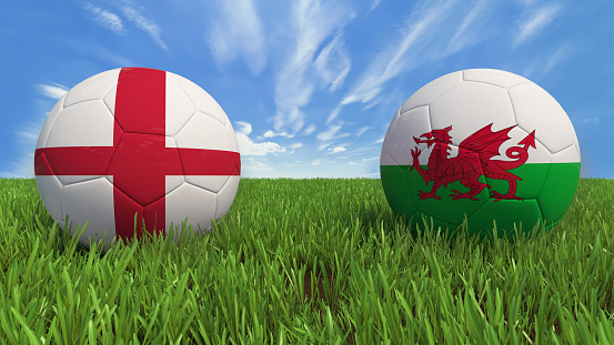 3D soccer balls with England and Wales flag, Euro 2016. Placed on 3d grass. Background isolated with clipping path.
