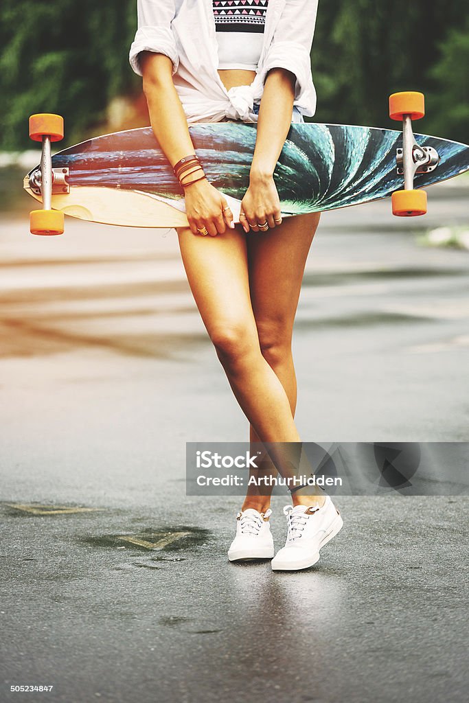 Fashion lifestyle, beautiful young woman with longboard Fashion lifestyle, beautiful young woman with longboard. Lightleak effect and instagram filter Adult Stock Photo