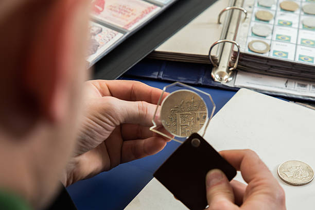 istock Two numismatists examines  collection of coin 505235078