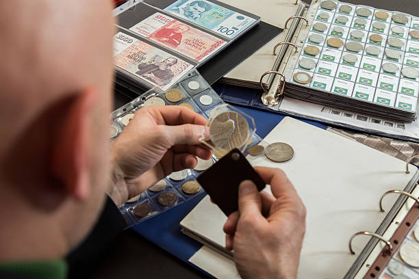 istock Two numismatists examines  collection of coin 505235794