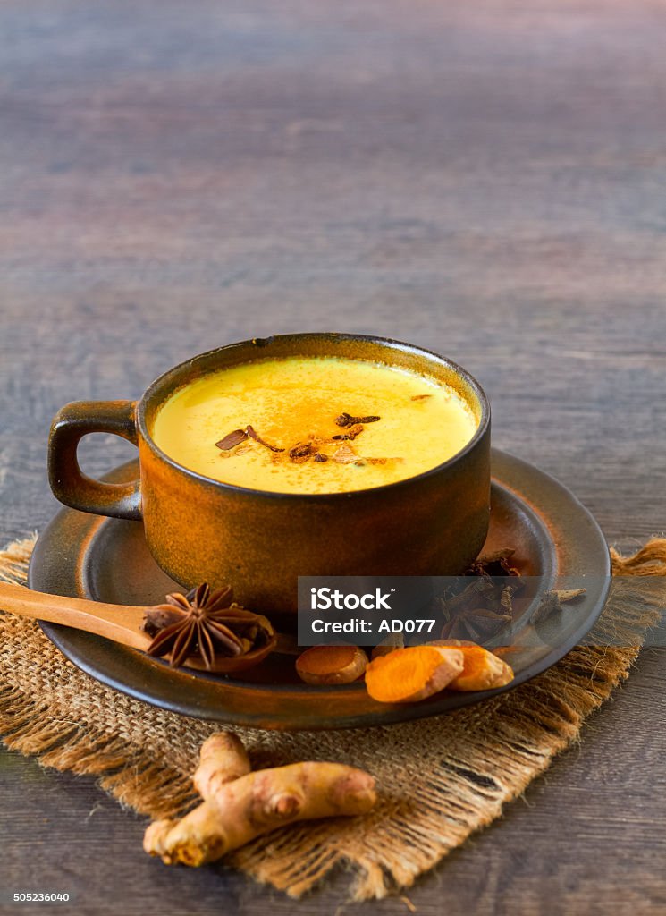 Indian masala chai with spices Healthy drink made from turmeric roots, exotic spices with milk and honey Haldi Ka Doodh Stock Photo