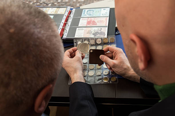 istock Two numismatists examines  collection of coin 505236224