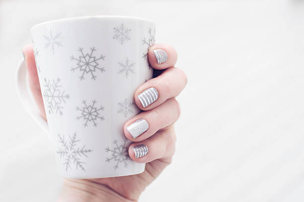 istock Hand holding mug with fancy nails. 505236562