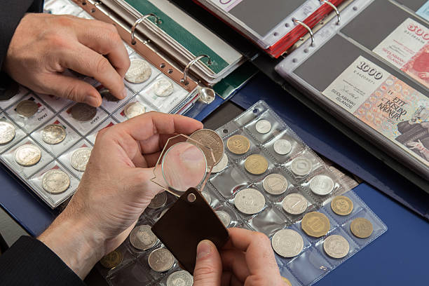 istock Two numismatists examines  collection of coin 505236590