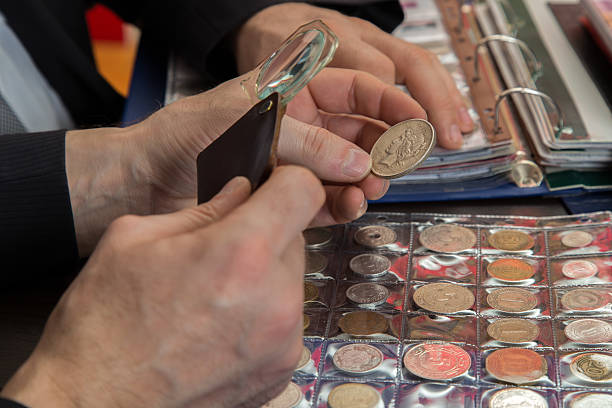 istock Two numismatists examines  collection of coin 505236774