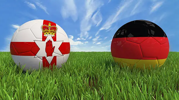 3D soccer balls with Northern Ireland and Germany flag, Euro 2016. Placed on 3d grass. Background isolated with clipping path.