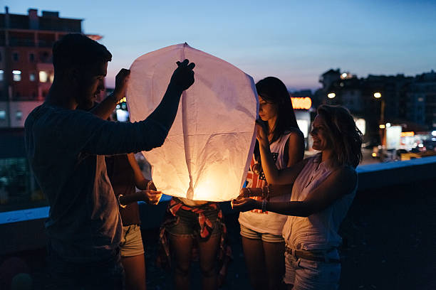 istock Friends releasing paper lantern 505238938