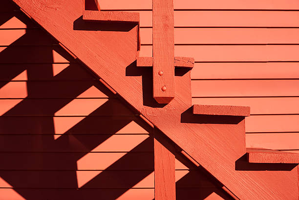 istock Red stairs of the red barn with shadows 505239192