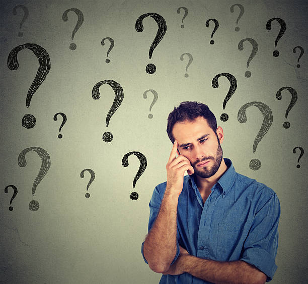 istock business man wondering looking down has many questions 505239294