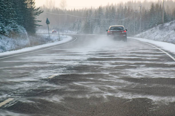Driving on curved backcountry road at snowstorm