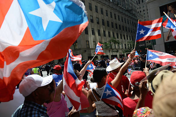 Puerto Rican Day Parade Supporters New York City New York City, USA - June 9, 2013: Supporters waving flags at the National Puerto Rican Day parade on Fifth Avenue, one of the largest parades in the city. puerto rican culture stock pictures, royalty-free photos & images