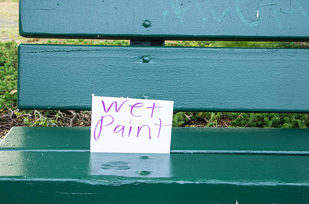 Wet paint A wet paint sign on a park bench. east boston stock pictures, royalty-free photos & images