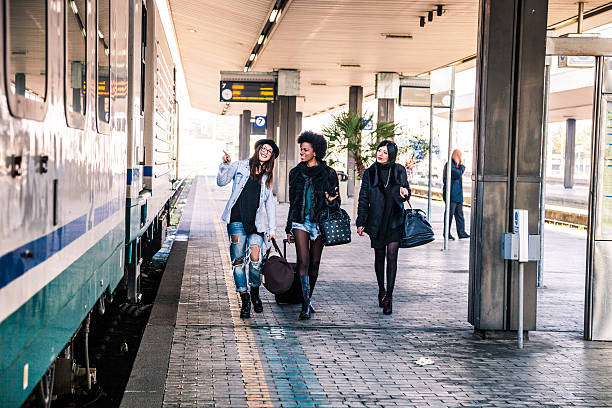 istock Friends at train station platform, tourist and commuters arriving 505257396