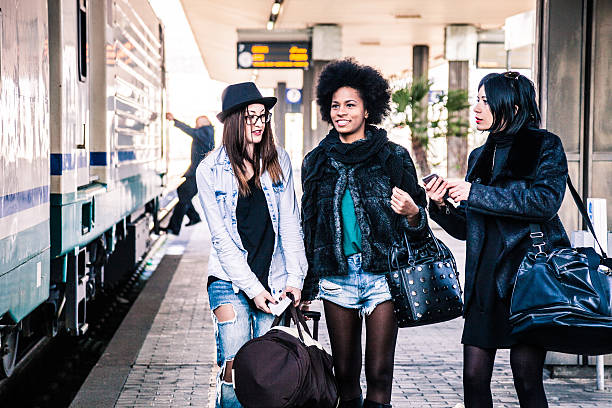 istock Friends at train station platform, tourist and commuters arriving 505257774