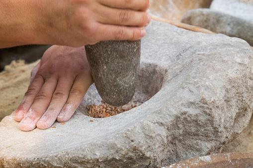 Making flour with stones in a traditional way for the Neolithic era.