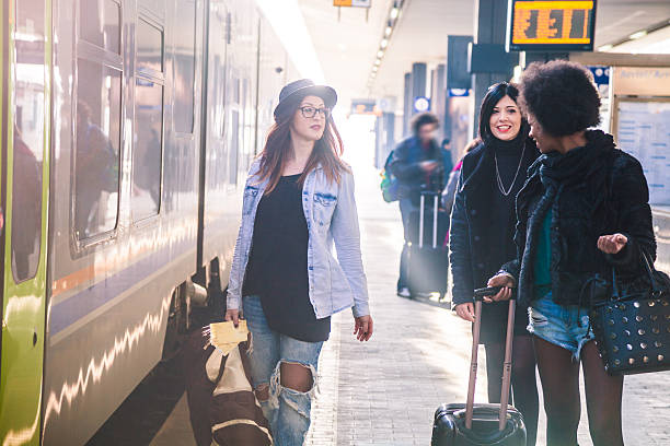 istock Friends at train station platform, tourist and commuters arriving 505259500