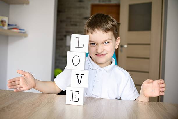istock Frustrated boy destroying brick tower he built. 505260262