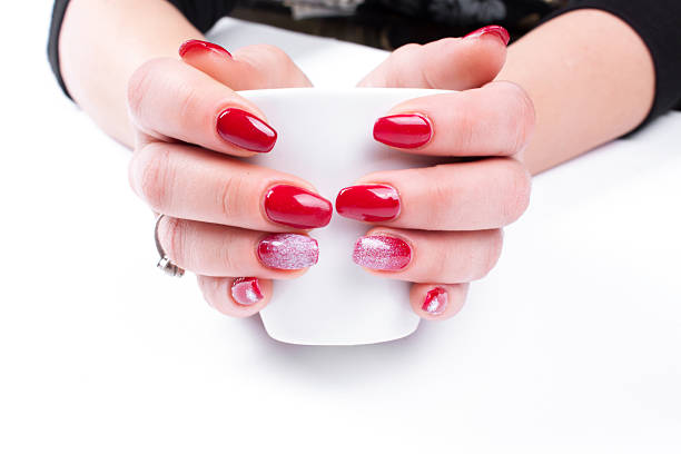istock Women's hands with a nice manicure and cup. Isolated 505262436