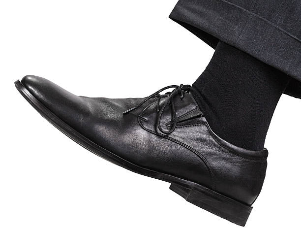 istock male left leg in black shoe takes a step 505262912