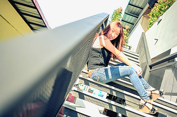 istock asia woman posing on ladder 505263278