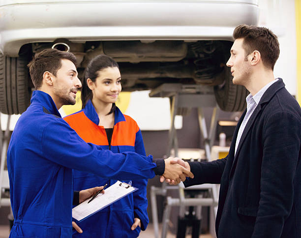 istock Auto Mechanic Talking With Car Owner 505265880